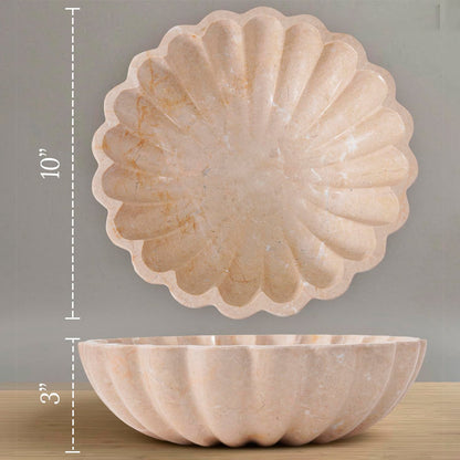 Decorative stone bowl with scalloped edge on a wooden surface, shown with measurements.