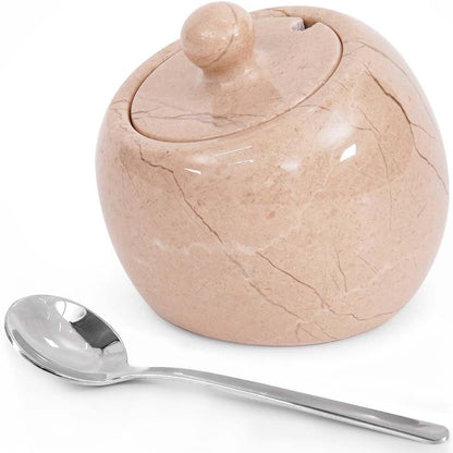 Marble-textured sugar bowl with a lid and a silver spoon on a white background
