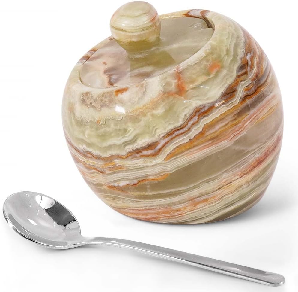 Marble-patterned sugar bowl with a spoon on a white background