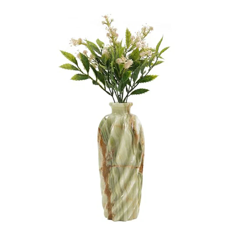 Decorative vase with marble pattern containing artificial flowers on a white background